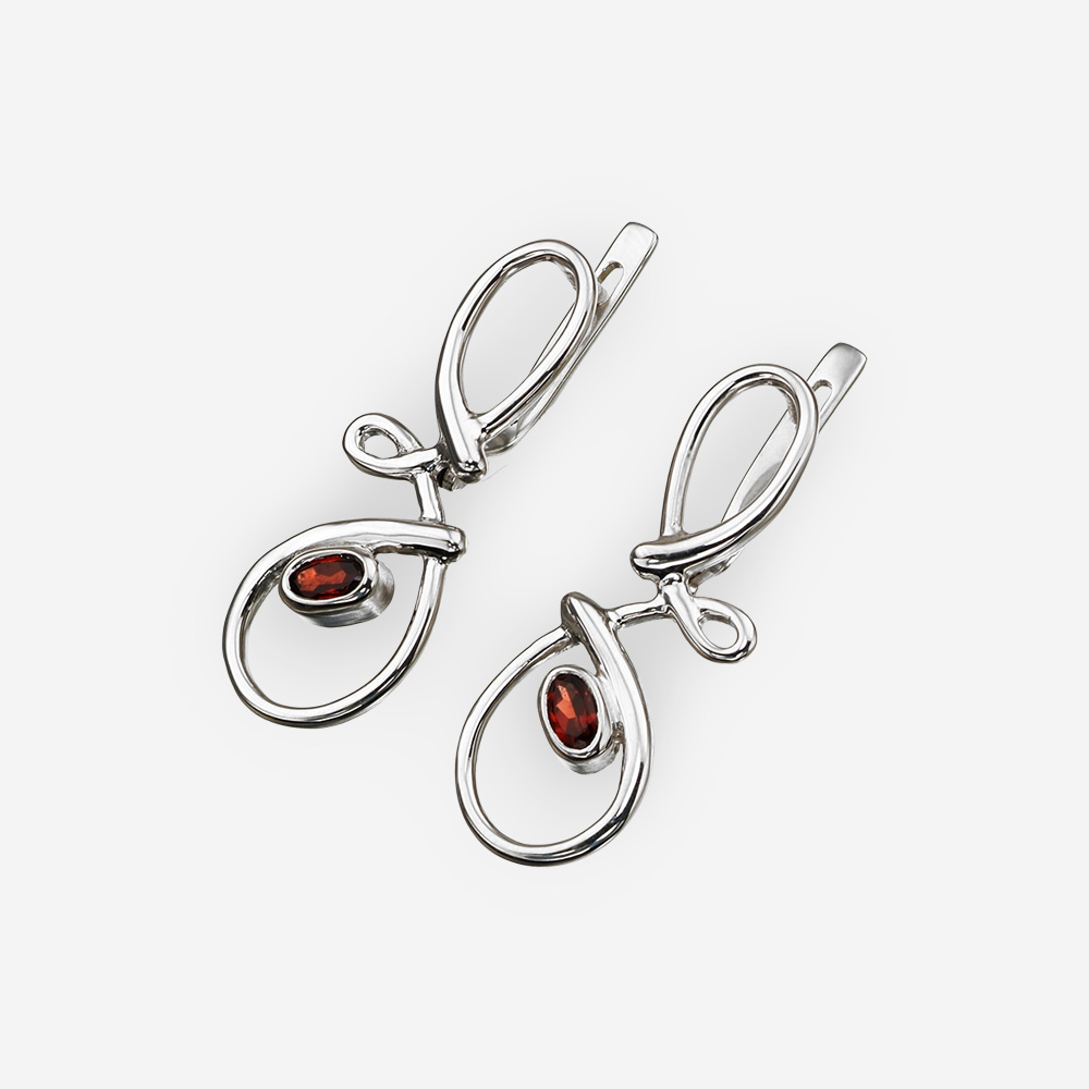 Abstract silver garnet earrings made from sterling silver and has latch back closures.