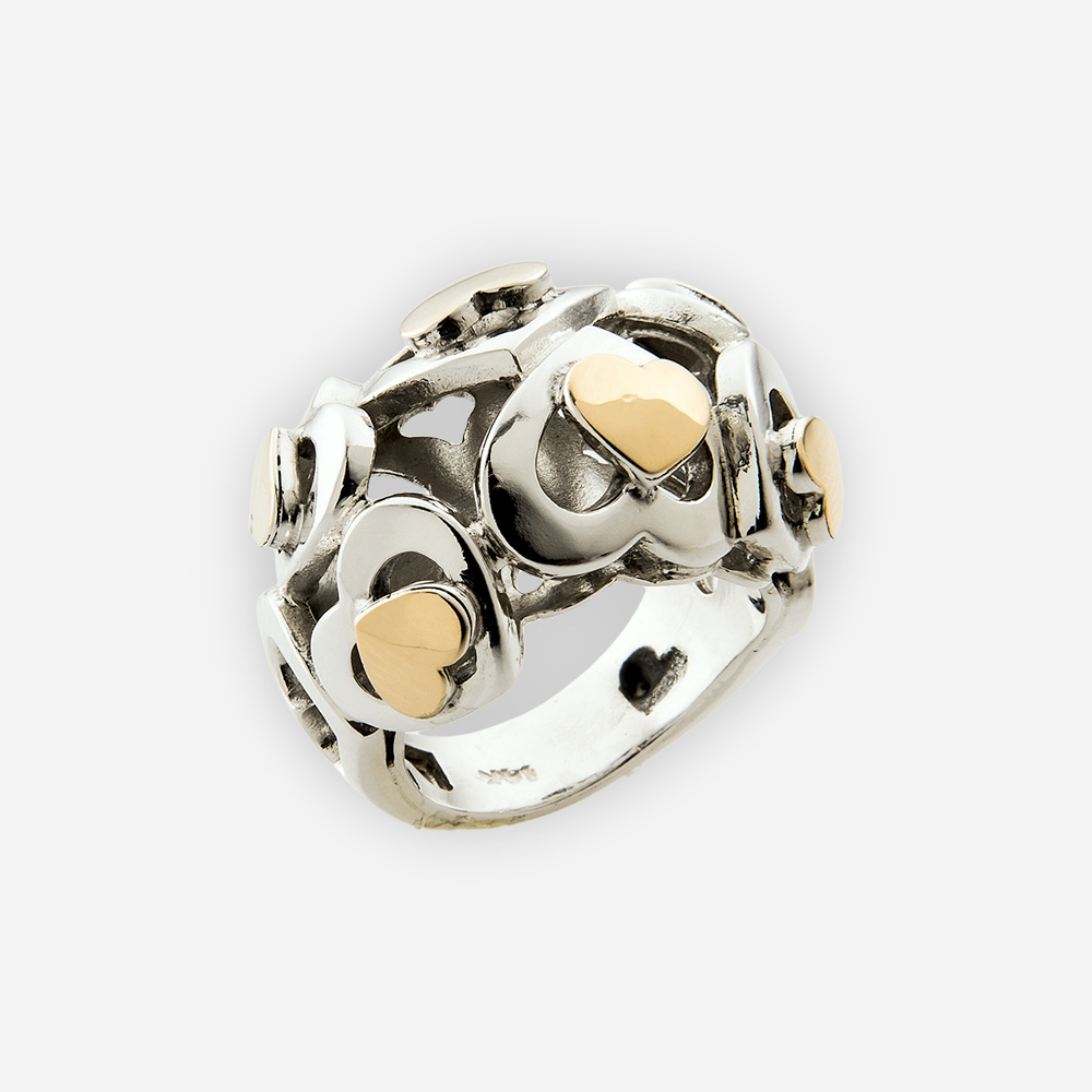 Domed silver cutout heart ring is crafted from 925 sterling silver and 14k gold with a polished finish.