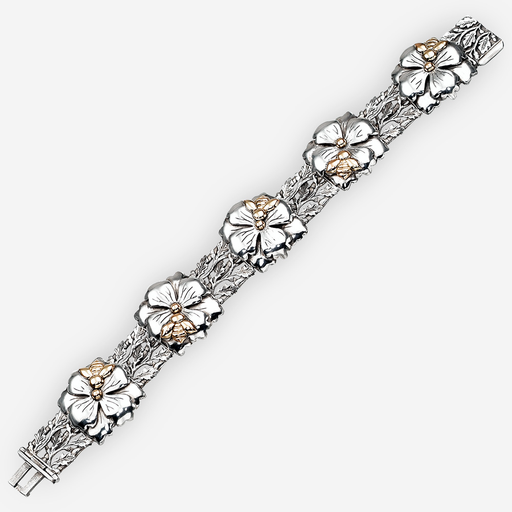 Floral silver bracelet with five flower links and 14k gold bee accents.