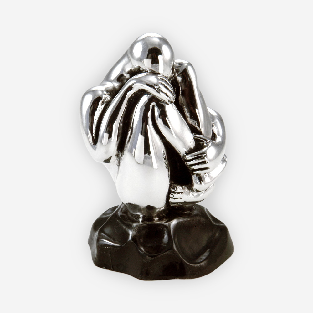 Grieving man silver sculpture is crafted with electroforming techniques and dipped in sterling silver.