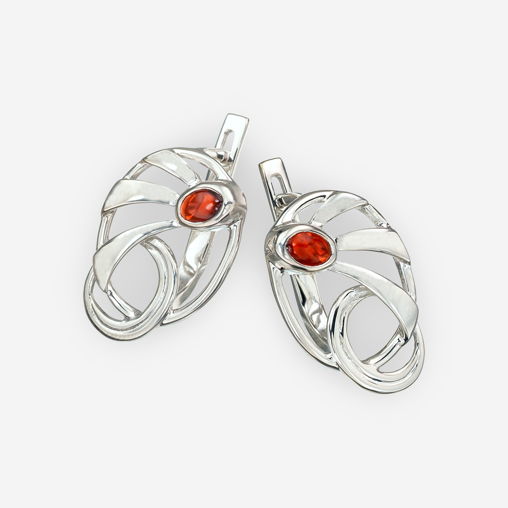 Modern silver garnet earrings with abstract sun beam design and latch back closures.