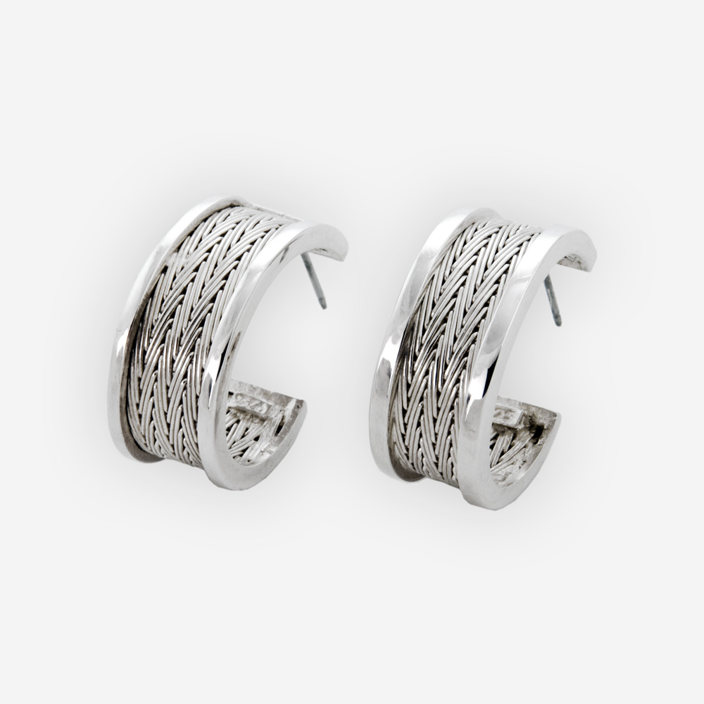 Semi-circle silver herringbone hoops crafted from 925 sterling silver and feature a handwoven herringbone pattern.