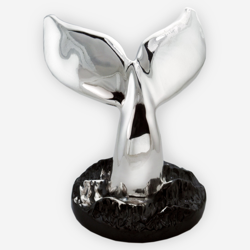 Silver whale tail sculpture is crafted with electroforming techniques and dipped in sterling silver.
