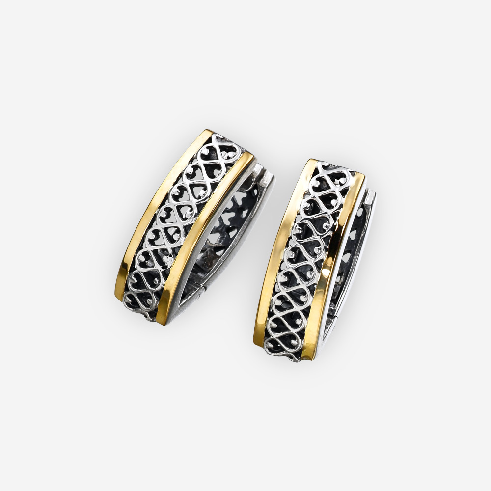 Sterling silver and 14k gold two tone huggie earrings with open filigree detailed design accented with gold elements.
