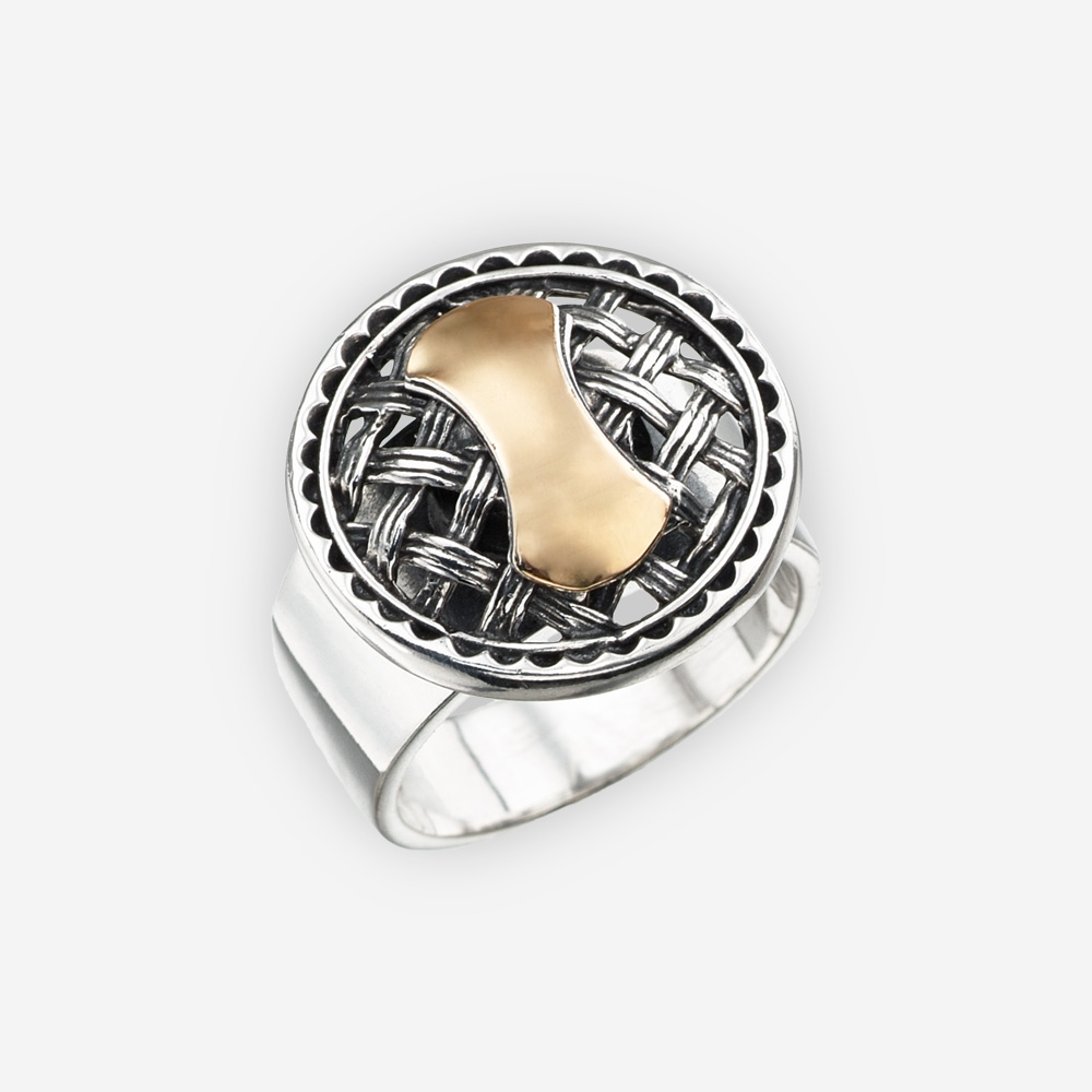 Two tone silver ring with an intricate lattice work medallion centerpiece and a gold design in the middle.