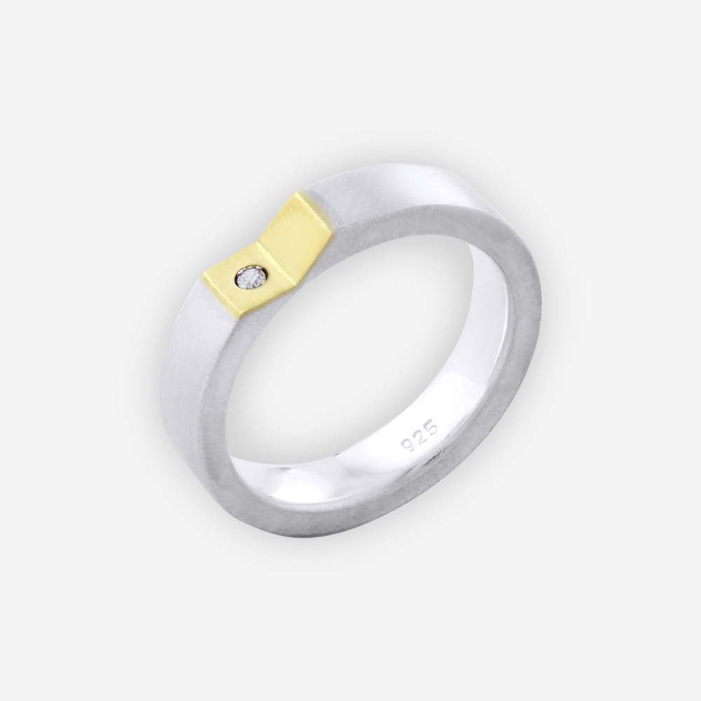 Unisex two tone silver modern band with polished finish, angled concave 14k gold upper, and small cubic zirconia stone.